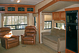 Slide-out living area of the Dogwood Acres fifth wheel rental trailer.